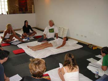 Aachan James, Master Thai Yoga teacher demonstrating and explaining Thai Yoga theory of Puja in Savasana Asana or Supine Position
