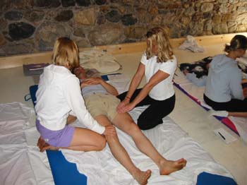 SomaVeda Thai Yoga students work in tandem practicing Thai Yoga for Multiple Therapists